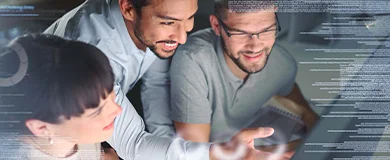 Researchers gather around a laptop to view data results